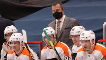 Feb 7, 2021; Washington, District of Columbia, USA; Philadelphia Flyers head coach Alain Vigneault (M) looks on from behind the bench against the Washington Capitals in the third period at Capital One Arena. Mandatory Credit: Geoff Burke-USA TODAY Sports