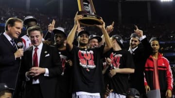 Apr 8, 2013; Atlanta, GA, USA; Louisville Cardinals guard Peyton Siva (center) holds the trophy after Louisville won the championship game in the 2013 NCAA mens Final Four against the Michigan Wolverines at the Georgia Dome. Louisville Cardinals won 82-76. Mandatory Credit: Bob Donnan-USA TODAY Sports