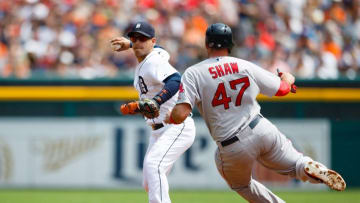 Aug 9, 2015; Detroit, MI, USA; Detroit Tigers shortstop Jose Iglesias (1) makes a throw to first in an attempted double play as Boston Red Sox first baseman Travis Shaw (47) slides into second in the second inning at Comerica Park. Mandatory Credit: Rick Osentoski-USA TODAY Sports