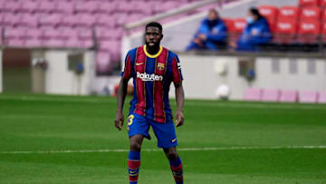 BARCELONA, SPAIN - APRIL 29: Samuel Umtiti of FC Barcelona with the ball during the La Liga Santander match between FC Barcelona and Granada CF at Camp Nou on April 29, 2021 in Barcelona, Spain. Sporting stadiums around Spain remain under strict restrictions due to the Coronavirus Pandemic as Government social distancing laws prohibit fans inside venues resulting in games being played behind closed doors. (Photo by Pedro Salado/Quality Sport Images/Getty Images)