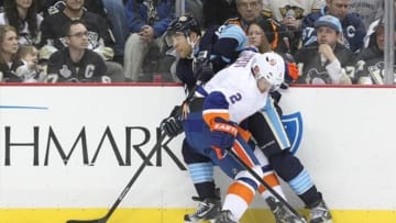 March 30, 2013; Pittsburgh, PA, USA; Pittsburgh Penguins right wing Jarome Iginla (left) and New York Islanders defenseman Mark Streit (2) battle for the puck along the boards during the second period at the CONSOL Energy Center. The Pittsburgh Penguins won 2-0. Mandatory Credit: Charles LeClaire-USA TODAY Sports