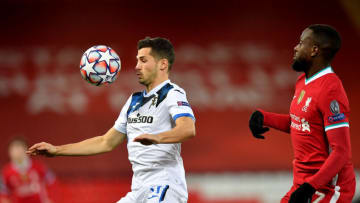 LIVERPOOL, ENGLAND - NOVEMBER 25: Cristian Romero of Atalanta B.C. looks to controls the ball with pressure from Divock Origi of Liverpool during the UEFA Champions League Group D stage match between Liverpool FC and Atalanta BC at Anfield on November 25, 2020 in Liverpool, England. Sporting stadiums around the UK remain under strict restrictions due to the Coronavirus Pandemic as Government social distancing laws prohibit fans inside venues resulting in games being played behind closed doors. (Photo by Paul Ellis - Pool/Getty Images)