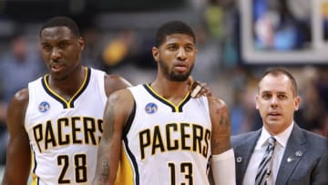 Apr 23, 2016; Indianapolis, IN, USA; Indiana Pacers center Ian Mahinmi (28) coach Frank Vogel and forward Paul George (13) walk back to the bench after a skirmish with the Toronto Raptors during the fourth quarter of game four of the first round of the 2016 NBA Playoffs at Bankers Life Fieldhouse. Indiana defeats Toronto 100-83. Mandatory Credit: Brian Spurlock-USA TODAY Sports