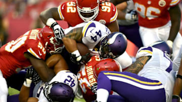 KANSAS CITY, MO - AUGUST 23: Matt Asiata #44 of the Minnesota Vikings is stopped by the Kansas City Chiefs defense during the first quarter at Arrowhead Stadium on August 23, 2014 in Kansas City, Missouri. (Photo by Peter Aiken/Getty Images)