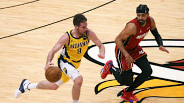 Mar 19, 2021; Miami, Florida, USA; Indiana Pacers guard T.J. McConnell (9) controls the basketball around Miami Heat guard Gabe Vincent (2) during the second quarter at American Airlines Arena. Mandatory Credit: Sam Navarro-USA TODAY Sports