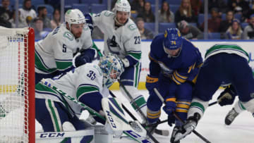 Oct 19, 2021; Buffalo, New York, USA; Vancouver Canucks goaltender Thatcher Demko (35) looks to make a save on Buffalo Sabres right wing Rasmus Asplund (74) during the second period at KeyBank Center. Mandatory Credit: Timothy T. Ludwig-USA TODAY Sports