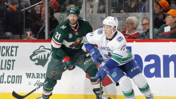 ST. PAUL, MN - NOVEMBER 15: Nikolay Goldobin #77 of the Vancouver Canucks looks to pass as Eric Fehr #21 of the Minnesota Wild looks on during a game at Xcel Energy Center on November 15, 2018 in St. Paul, Minnesota. The Wild defeated the Canucks 6-2.(Photo by Bruce Kluckhohn/NHLI via Getty Images)