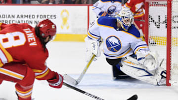 Mar 18, 2022; Calgary, Alberta, CAN; Buffalo Sabres goalie Dustin Tokarski (31) stops a shot from Calgary Flames defenseman Christopher Tanev (8) during the third period at Scotiabank Saddledome. Sabres won 1-0. Mandatory Credit: Candice Ward-USA TODAY Sports