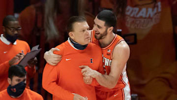 Jan 19, 2021; Champaign, Illinois, USA; Illinois Fighting Illini forward Giorgi Bezhanishvili (R) reacts while embracing head coach Brad Underwood during the first half against the Penn State Nittany Lions at the State Farm Center. Mandatory Credit: Patrick Gorski-USA TODAY Sports