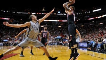 Jan 26, 2014; Miami, FL, USA; Miami Heat small forward Michael Beasley (8) shoots over San Antonio Spurs shooting guard Manu Ginobili (20) during the first half at American Airlines Arena. Mandatory Credit: Steve Mitchell-USA TODAY Sports