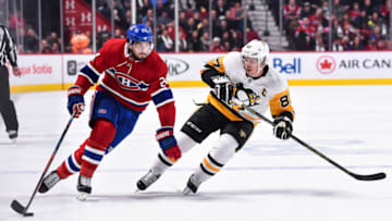 MONTREAL, QC - OCTOBER 13: Phillip Danault #24 of the Montreal Canadiens skates the puck against Sidney Crosby #87 of the Pittsburgh Penguins during the NHL game at the Bell Centre on October 13, 2018 in Montreal, Quebec, Canada. The Montreal Canadiens defeated the Pittsburgh Penguins 4-3 in a shootout. (Photo by Minas Panagiotakis/Getty Images)