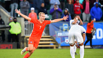 Dec 12, 2021; Cary, NC, USA; Clemson forward Tim Strobeck (7) celebrates as Washington midfielder Kalani Kossa-Rienzi (6) and defender Kendall Burks (2) react at the end of the game at WakeMed Soccer Park. Clemson defeated Washington 2-0. Mandatory Credit: Bob Donnan-USA TODAY Sports