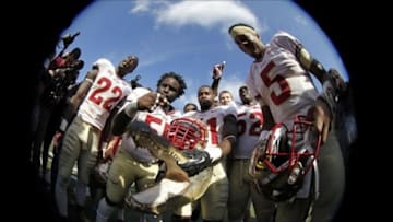 Nov 30, 2013; Gainesville, FL, USA; Florida State Seminoles quarterback Jameis Winston (5) and teammates put a Florida State Seminoles helmet on top of the gator head after they beat the Florida Gators at Ben Hill Griffin Stadium. Florida State Seminoles defeated the Florida Gators 37-7. Mandatory Credit: Kim Klement-USA TODAY Sports