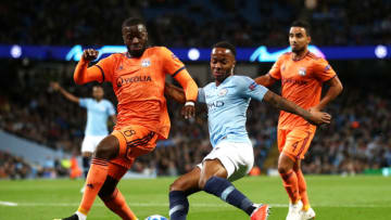 MANCHESTER, ENGLAND - SEPTEMBER 19: Raheem Sterling of Manchester City shoots while under pressure from Tanguy NDombele Alvaro of Lyon during the Group F match of the UEFA Champions League between Manchester City and Olympique Lyonnais at Etihad Stadium on September 19, 2018 in Manchester, United Kingdom. (Photo by Julian Finney/Getty Images)
