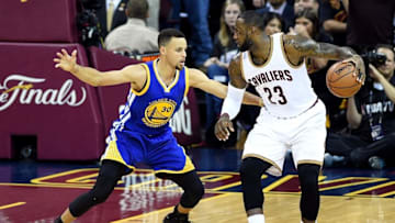 Jun 16, 2016; Cleveland, OH, USA; Cleveland Cavaliers forward LeBron James (23) handles the ball against Golden State Warriors guard Stephen Curry (30) during the first quarter in game six of the NBA Finals at Quicken Loans Arena. Mandatory Credit: Bob Donnan-USA TODAY Sports