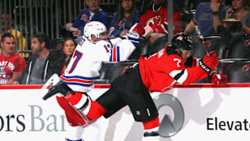 NEWARK, NEW JERSEY - SEPTEMBER 20: Jesper Fast #17 of the New York Rangers and Matt Tennyson #7 of the New Jersey Devils collide on the boards during the first period at the Prudential Center on September 20, 2019 in Newark, New Jersey. (Photo by Bruce Bennett/Getty Images)