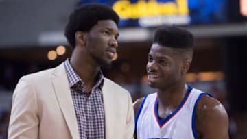 March 24, 2015; Sacramento, CA, USA; Philadelphia 76ers center Nerlens Noel (4) talks to center Joel Embiid (21, left) during the second quarter against the Sacramento Kings at Sleep Train Arena. The Kings defeated the 76ers 107-106. Mandatory Credit: Kyle Terada-USA TODAY Sports