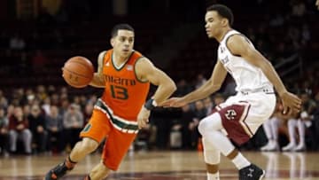 Jan 20, 2016; Chestnut Hill, MA, USA; Miami Hurricanes guard Angel Rodriguez (13) drives past Boston College Eagles guard Jerome Robinson (1) during the first half at Silvio O. Conte Forum. Mandatory Credit: Greg M. Cooper-USA TODAY Sports
