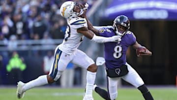 BALTIMORE, MARYLAND - JANUARY 06: Quarterback Lamar Jackson #8 of the Baltimore Ravens stiff arms free safety Derwin James #33 of the Los Angeles Chargers in the second half during the AFC Wild Card Playoff game at M&T Bank Stadium on January 06, 2019 in Baltimore, Maryland. (Photo by Patrick Smith/Getty Images)