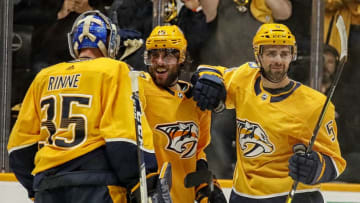 NASHVILLE, TENNESSEE - APRIL 13: Pekka Rinne #35 and Dan Hamhuis #5 of the Nashville Predators congratulate teammate Craig Smith #15 after scoring the game-winning goal of 2-1 Predators victory over the Dallas Stars in Game Two of the Western Conference First Round during the 2019 NHL Stanley Cup Playoffs at Bridgestone Arena on April 13, 2019 in Nashville, Tennessee. (Photo by Frederick Breedon/Getty Images)
