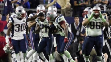 Feb 1, 2015; Glendale, AZ, USA; New England Patriots strong safety Malcolm Butler (21) celebrates with teammates after intercepting a pass against the Seattle Seahawks in the fourth quarter in Super Bowl XLIX at University of Phoenix Stadium. Mandatory Credit: Kyle Terada-USA TODAY Sports
