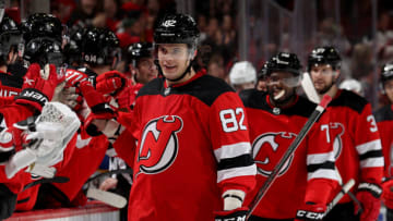 NEWARK, NEW JERSEY - APRIL 21: Nikita Okhotiuk #82 of the New Jersey Devils celebrates his first career NHL goal with teammates on the bench during the third period against the Buffalo Sabres at Prudential Center on April 21, 2022 in Newark, New Jersey. The Buffalo Sabres defeated the New Jersey Devils 5-2. (Photo by Elsa/Getty Images)