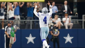 Oct 3, 2021; Arlington, Texas, USA; Dallas Cowboys quarterback Dak Prescott (4) reacts to a touchdown in the third quarter against the Carolina Panthers at AT&T Stadium. Mandatory Credit: Tim Heitman-USA TODAY Sports