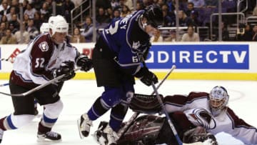 LOS ANGELES - JANUARY 29: Scott Barney #62 of the Los Angeles Kings tries to put the loose puck past goaltender David Aebischer #1 of the Colorado Avalanche in the second period on January 29, 2004 at Staples Center in Los Angeles, California. (Photo by Victor Decolongon/Getty Images)