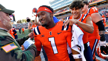 Nov 11, 2023; Champaign, Illinois, USA; Illinois Fighting Illini wide receiver Isaiah Williams (1) is congratulated after he caught the winning touchdown pass in overtime to defeat the Indiana Hoosiers at Memorial Stadium. Mandatory Credit: Ron Johnson-USA TODAY Sports