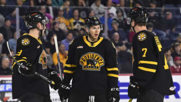 LAVAL, QC - OCTOBER 16: Jeremy Lauzon #15 of the Providence Bruins(C) speaks with teammates Zachary Senyshyn #9 (L) and Trent Frederic #7 (R) against the Laval Rocket at Place Bell on October 16, 2019 in Laval, Canada. The Laval Rocket defeated the Providence Bruins 5-4 in a shoot-out. (Photo by Minas Panagiotakis/Getty Images)