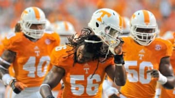 Aug 31, 2014; Knoxville, TN, USA; Tennessee Volunteers defensive lineman Curt Maggitt (56) removes his helmet to shake the rain from his hair as he departs the field after warm ups prior to the game against the Utah State Aggies at Neyland Stadium. Mandatory Credit: Jim Brown-USA TODAY Sports
