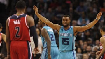 Feb 6, 2016; Charlotte, NC, USA; Charlotte Hornets guard Kemba Walker (15) gets the crowd into the game as he defends against Washington Wizards guard John Wall (2) during the second half at Time Warner Cable Arena. Hornets win 108-104. Mandatory Credit: Sam Sharpe-USA TODAY Sports