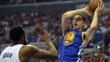 Apr 21, 2014; Los Angeles, CA, USA; Golden State Warriors guard Klay Thompson (11) shoots against Los Angeles Clippers center DeAndre Jordan (6) during the first quarter in game two during the first round of the 2014 NBA Playoffs at Staples Center. Mandatory Credit: Richard Mackson-USA TODAY Sports