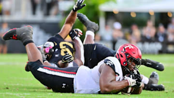 Cincinnati Bearcats defensive tackle Dontay Corleone recovers a fumble against the UCF Knights. Getty Images.