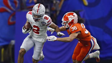 Ohio State Buckeyes wide receiver Chris Olave (2) heads up field after a catch against Clemson Tigers safety Lannden Zanders (36) in the second quarter during the College Football Playoff semifinal at the Allstate Sugar Bowl in the Mercedes-Benz Superdome in New Orleans on Friday, Jan. 1, 2021.College Football Playoff Ohio State Faces Clemson In Sugar Bowl