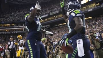 Sep 4, 2014; Seattle, WA, USA; Seattle Seahawks fullback Derrick Coleman (40, right) celebrates his 15-yard touchdown reception with tackle Russell Okung (76) during the fourth quarter against the Green Bay Packers at CenturyLink Field. Mandatory Credit: Joe Nicholson-USA TODAY Sports