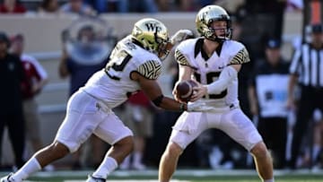 Sep 24, 2016; Bloomington, IN, USA; Wake Forest Demon Deacons quarterback John Wolford (10) hands off the ball to Wake Forest Demon Deacons fullback Charles Argenzio (32) during the second half of the game at Memorial Stadium. The Wake Forest Demon Deacons defeated the Indiana Hoosiers 33 to 28. Mandatory Credit: Marc Lebryk-USA TODAY Sports