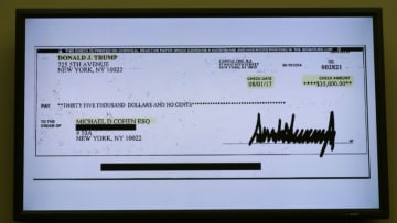 WASHINGTON, DC - FEBRUARY 27: A copy of a check paid to Michael Cohen by President Trump is displayed as Michael Cohen, former attorney and fixer for President Donald Trump testifies before the House Oversight Committee on Capitol Hill February 27, 2019 in Washington, DC. Last year Cohen was sentenced to three years in prison and ordered to pay a $50,000 fine for tax evasion, making false statements to a financial institution, unlawful excessive campaign contributions and lying to Congress as part of special counsel Robert Mueller's investigation into Russian meddling in the 2016 presidential elections. (Photo by Chip Somodevilla/Getty Images)
