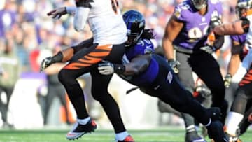 Nov 10, 2013; Baltimore, MD, USA; Cincinnati Bengals quarterback Andy Dalton (14) throws a pass while being pressured by Baltimore Ravens linebacker Pernell McPhee (90) at M&T Bank Stadium. Mandatory Credit: Evan Habeeb-USA TODAY Sports