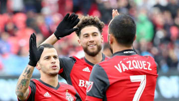 TORONTO, ON - April 28 In first half action, Toronto FC forward Sebastian Giovinco (10) Jonathan Osorio (21) celebrate Toronto FC midfielder Victor Vazquez' goal.Toronto FC (TFC) hosts Chicago Fire in MLS soccer action at BMO Field in Toronto.April 28, 2018 (Richard Lautens/Toronto Star via Getty Images)