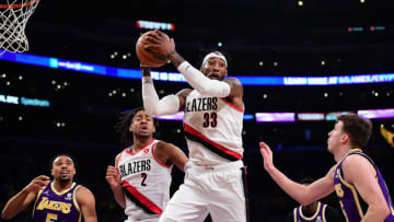 Feb 2, 2022; Los Angeles, California, USA; Portland Trail Blazers forward Robert Covington (33) gets the rebound in front of Los Angeles Lakers guard Talen Horton-Tucker (5) and guard Talen Horton-Tucker (5) during the second half at Crypto.com Arena. Mandatory Credit: Gary A. Vasquez-USA TODAY Sports