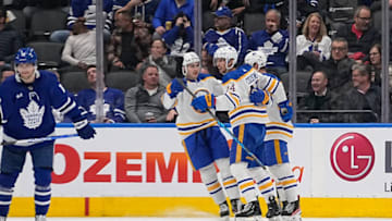 Mar 13, 2023; Toronto, Ontario, CAN; Buffalo Sabres forward Jack Quinn (22) congratulates forward Dylan Cozens (24) after his goal against the Toronto Maple Leafs during the third period at Scotiabank Arena. Mandatory Credit: John E. Sokolowski-USA TODAY Sports
