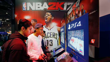 PARIS, FRANCE - OCTOBER 28: Gamers play the video game 'NBA 2K 17' developed by Visual Concepts and published 2K Sports on Sony PlayStation game consoles PS4 during the 'Paris Games Week' on October 28, 2016 in Paris, France. 'Paris Games Week' is an international trade fair for video games to be held from October 27 to October 31, 2016. (Photo by Chesnot/Getty Images)