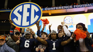Auburn footballATLANTA, GA - DECEMBER 07: Jeremy Johnson #6 of the Auburn Tigers and teammate Trovon Reed #1 celebrate with fans after defeating the Missouri Tigers 59-42 to win the SEC Championship Game at Georgia Dome on December 7, 2013 in Atlanta, Georgia. (Photo by Mike Ehrmann/Getty Images)