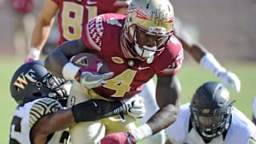 Oct 15, 2016; Tallahassee, FL, USA; Florida State Seminoles running back Dalvin Cook (4) runs past Wake Forest Demon Deacons linebacker Thomas Brown (26) during the game at Doak Campbell Stadium. Mandatory Credit: Melina Vastola-USA TODAY Sports