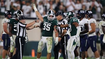 EAST LANSING, MI - AUGUST 31: Joe Bachie #35 of the Michigan State Spartans celebrates a late fourth quarter interception while playing the Utah State Aggies at Spartan Stadium on August 31, 2018 in East Lansing, Michigan. Michigan State won the game 38-31. (Photo by Gregory Shamus/Getty Images)