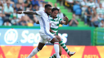 LISBON, PORTUGAL - JULY 23: Lyon's forward Alexandre Lacazette with Sporting CP's defender Ezequiel Schelotto from Argentina in action during the Pre Season Friendly match between Sporting CP and Lyon at Estadio Jose Alvalade on July 23, 2016 in Lisbon, Portugal. (Photo by Gualter Fatia/Getty Images)