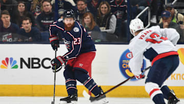 COLUMBUS, OH - APRIL 17: Ian Cole #23 of the Columbus Blue Jackets skates with the puck as Jakub Vrana #13 of the Washington Capitals defends during the first period in Game Three of the Eastern Conference First Round during the 2018 NHL Stanley Cup Playoffs at Nationwide Arena in Columbus, Ohio. (Photo by Jamie Sabau/NHLI via Getty Images)