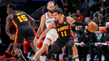 Nov 27, 2021; Atlanta, Georgia, USA; Atlanta Hawks guard Trae Young (11) dribbles in front of New York Knicks guard Evan Fournier (13) during the first half at State Farm Arena. Mandatory Credit: Dale Zanine-USA TODAY Sports