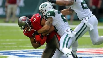 Sep 8, 2013; East Rutherford, NJ, USA; Tampa Bay Buccaneers wide receiver Vincent Jackson (83) is tackled by New York Jets corner back Dee Milliner (27) during the first quarter of a game at MetLife Stadium. Mandatory Credit: Brad Penner-USA TODAY Sports